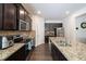 Gourmet kitchen featuring granite countertops, stainless steel appliances, and dark wood cabinetry at 2631 Lovejoy Crossing Dr, Hampton, GA 30228