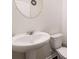 Modern powder room featuring a pedestal sink, neutral wall color, and a decorative mirror at 2631 Lovejoy Crossing Dr, Hampton, GA 30228