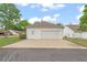 Two-car detached garage with driveway and minimal landscaping at 310 Autumn Glen Cir, Fayetteville, GA 30215