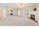 Bright living room with a fireplace, large mirror, and ample natural light at 310 Autumn Glen Cir, Fayetteville, GA 30215