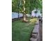 Manicured backyard lawn offers privacy and serenity, framed by mature trees and a retaining wall at 3978 Devonshire Dr, Marietta, GA 30066