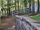 Scenic backyard featuring a pristine lawn, retaining wall and a glimpse of the backyard gazebo at 3978 Devonshire Dr, Marietta, GA 30066