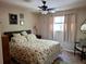 This bedroom features a ceiling fan and a sunny window with neutral-toned curtains at 3978 Devonshire Dr, Marietta, GA 30066