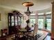 Formal dining room features decorative light fixture, bay windows, and hardwood flooring at 3978 Devonshire Dr, Marietta, GA 30066