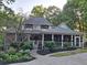 Beautiful exterior view showcasing the home's architecture, a screened in porch, and lush landscaping at 3978 Devonshire Dr, Marietta, GA 30066