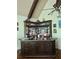 Elaborate home bar with dark wood cabinetry, stained glass, and brass accents at 3978 Devonshire Dr, Marietta, GA 30066