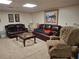 Inviting living room featuring leather sofas, patterned chair, a glass coffee table, and neutral carpeting at 3978 Devonshire Dr, Marietta, GA 30066