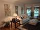 Inviting living room featuring hardwood floors, neutral decor, and plenty of natural light at 3978 Devonshire Dr, Marietta, GA 30066