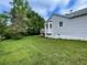 Side view of a home with light gray siding, a bay window, and a lush green lawn at 53 Villa Rosa Way, Temple, GA 30179