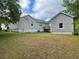 Side view of the house showcasing a large grassy backyard and detached garage at 53 Villa Rosa Way, Temple, GA 30179