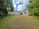 View of backyard with home and detached one car garage at 53 Villa Rosa Way, Temple, GA 30179