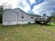 Backyard view featuring a deck and a path on a grassy lawn at 53 Villa Rosa Way, Temple, GA 30179