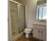 Bathroom features a shower stall, toilet, small sink with storage, and tile floor at 53 Villa Rosa Way, Temple, GA 30179