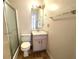 Bathroom featuring shower with glass door, toilet, sink with storage, and tile floor at 53 Villa Rosa Way, Temple, GA 30179