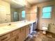Bright bathroom features a double sink vanity and a shower with glass doors at 53 Villa Rosa Way, Temple, GA 30179