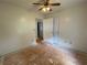 Bedroom with a sliding closet door, ceiling fan, and unfinished flooring at 53 Villa Rosa Way, Temple, GA 30179