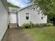 Side view of home showcasing siding, trimmed landscaping, window, and door at 53 Villa Rosa Way, Temple, GA 30179