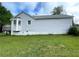 Side view of a home with light gray siding, a bay window, and a lush green lawn at 53 Villa Rosa Way, Temple, GA 30179
