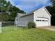 View of detached garage with a white door and adjacent fenced-in area at 53 Villa Rosa Way, Temple, GA 30179
