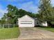 Front exterior of a home with a driveway, fenced in yard, lush green grass, and attached garage at 53 Villa Rosa Way, Temple, GA 30179