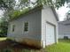 Detached garage with siding, a garage door and a side door at 53 Villa Rosa Way, Temple, GA 30179