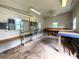 View of the garage featuring ceiling lights, a fan, shelving, windows, and work benches at 53 Villa Rosa Way, Temple, GA 30179