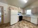 Neutral kitchen featuring a window and white appliances at 53 Villa Rosa Way, Temple, GA 30179