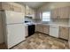 Bright kitchen features white appliances, neutral cabinets, and linoleum floors at 53 Villa Rosa Way, Temple, GA 30179