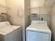 Functional laundry room equipped with washer, dryer, and storage shelves at 53 Villa Rosa Way, Temple, GA 30179