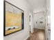Hallway featuring wood floors, artwork, coat closet, half bath and a door to the garage at 9452 Pinecrest Path # 314, Jonesboro, GA 30238