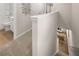 Upstairs hallway featuring neutral carpet and views down to the main living area of the home at 9452 Pinecrest Path # 314, Jonesboro, GA 30238