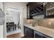 Elegant bar area featuring custom cabinets, wine rack, and countertop with wine refrigerator at 1165 Victoria Ne St, Brookhaven, GA 30319