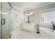 Stylish bathroom features white cabinetry, soaking tub, and glass-enclosed shower at 1165 Victoria Ne St, Brookhaven, GA 30319