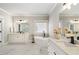 Bright bathroom featuring double vanities, soaking tub, and marble floors at 1165 Victoria Ne St, Brookhaven, GA 30319