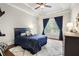 Cozy bedroom features a tray ceiling, hardwood floors, and a bright window at 1165 Victoria Ne St, Brookhaven, GA 30319