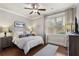 The bedroom is bright and has hardwood floors, a ceiling fan and neutral decor at 1165 Victoria Ne St, Brookhaven, GA 30319