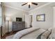 The bedroom has hardwood floors, ceiling fan, and gray dresser at 1165 Victoria Ne St, Brookhaven, GA 30319
