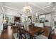 Open-concept dining area adjacent to a living area and kitchen, filled with natural light at 1165 Victoria Ne St, Brookhaven, GA 30319