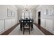Formal dining room featuring wainscoting, a modern chandelier, and an elegant dining set at 1165 Victoria Ne St, Brookhaven, GA 30319