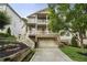 Inviting two-story home with double porches, stone accents, and a driveway leading to the garage at 1165 Victoria Ne St, Brookhaven, GA 30319