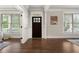 Elegant foyer featuring hardwood floors, white trim, and a dark wood front door at 1165 Victoria Ne St, Brookhaven, GA 30319