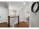 Upstairs hallway with hardwood floors, detailed trim, and an decorative mirror at 1165 Victoria Ne St, Brookhaven, GA 30319