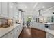 Modern kitchen with white cabinets, stainless steel appliances, and marble countertops at 1165 Victoria Ne St, Brookhaven, GA 30319