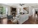 Open-concept living room boasts a stone fireplace and staircase, perfect for entertaining at 1165 Victoria Ne St, Brookhaven, GA 30319