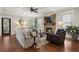 Inviting living room features a cozy fireplace, hardwood floors, and coffered ceiling at 1165 Victoria Ne St, Brookhaven, GA 30319