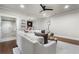 The living room has wood floors, a ceiling fan, ATL lights and access to a wet bar at 1165 Victoria Ne St, Brookhaven, GA 30319