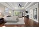 Expansive main bedroom features a tray ceiling, hardwood floors, and access to private balcony at 1165 Victoria Ne St, Brookhaven, GA 30319
