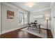 Bright home office with hardwood floors, a modern glass desk, and a large window at 1165 Victoria Ne St, Brookhaven, GA 30319