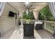 Enjoy the outdoors on this covered patio featuring a ceiling fan and privacy drapes at 1165 Victoria Ne St, Brookhaven, GA 30319