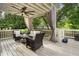 Relaxing covered patio with overhead fan, comfortable seating, and privacy curtains at 1165 Victoria Ne St, Brookhaven, GA 30319